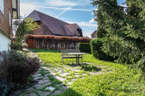 a park bench sitting in the middle of a yard at Hirschenhäusle in Sankt Märgen