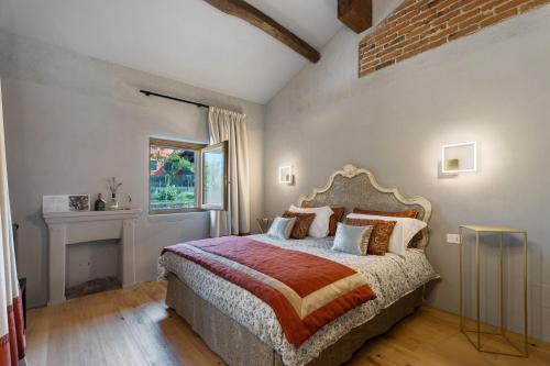 a bedroom with a large bed and a window at Decanter House in Borgomanero