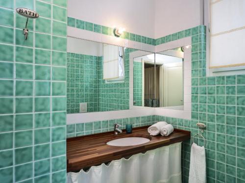 a bathroom with a sink and a mirror at Li Conchi 44 in Castiadas