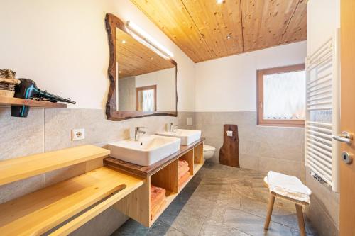 a bathroom with a sink and a mirror at Seppnerhof Ferienwohnung Enzian in Moso