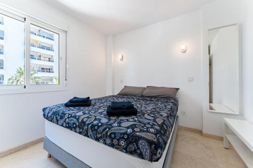 a bedroom with a bed in a white room at Paraiso in Fuengirola
