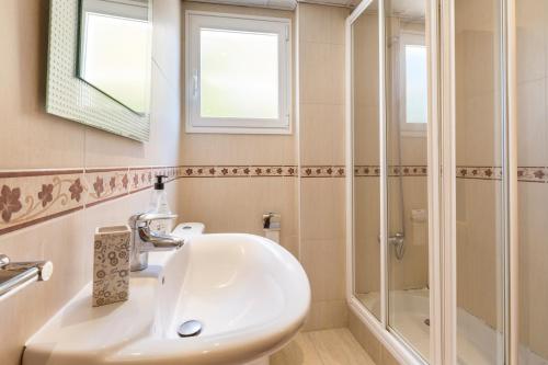 a bathroom with a sink and a shower at La Cala in Cabo de Palos