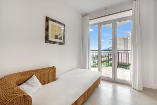 a white living room with a couch and a window at Javea Brisas Del Mar Cofisa in Jávea