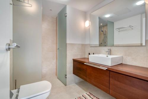 a bathroom with a sink and a toilet and a mirror at Javea Brisas Del Mar Cofisa in Jávea