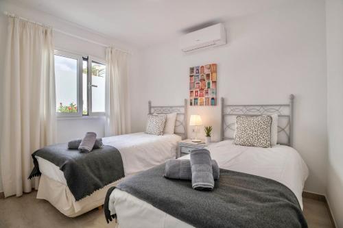 a bedroom with two beds and a window at Alegria in Puerto del Carmen