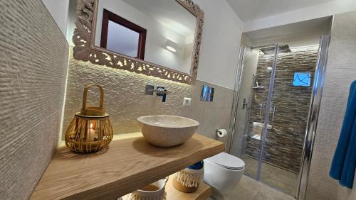a bathroom with a bowl sink and a shower at Villa Luna Rossa con piscina in San Teodoro