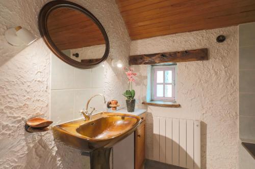 a bathroom with a sink and a mirror at Gîte Ty Coz in Lanvellec