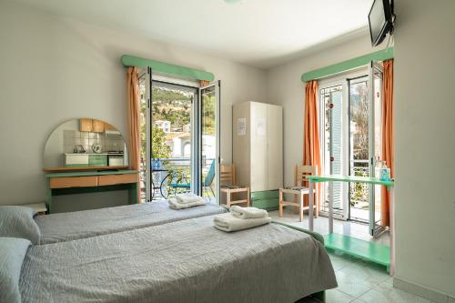 a bedroom with a bed with two towels on it at Angela partial sea view 9 in Kefallonia