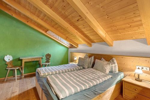 a bedroom with two beds and a wooden ceiling at Plazores in San Vigilio Di Marebbe