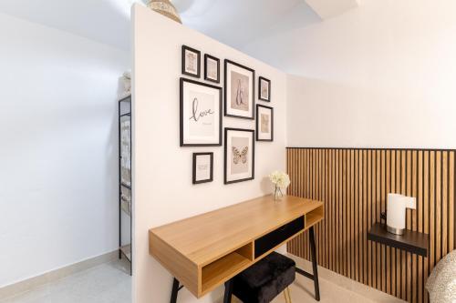 a room with a desk and pictures on the wall at El Castañar de Ceubia in Arenas de San Pedro