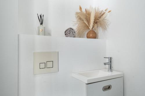 a white bathroom with a sink and a counter at T2 Cyril Besset in Cagnes-sur-Mer