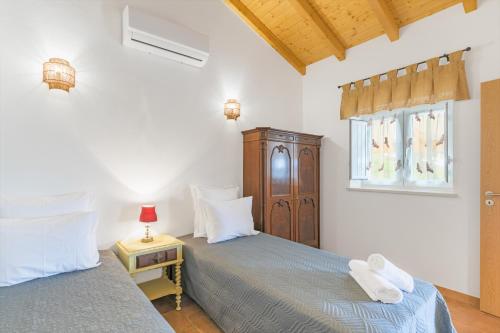a bedroom with two beds and a window at Casa da Ti Mónica in São Luis