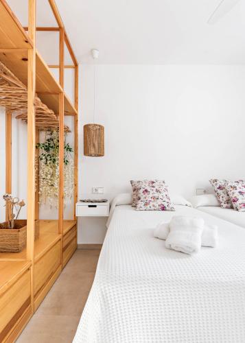 two beds in a bedroom with white walls at Marce in Ciutadella