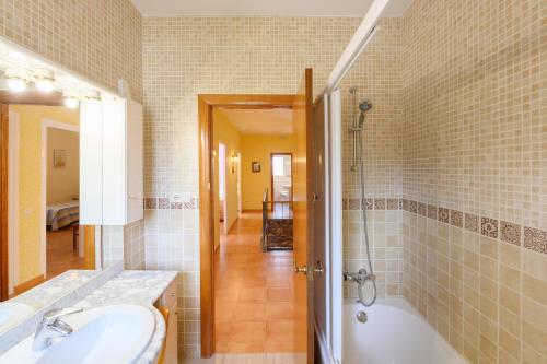 a bathroom with a tub and a sink and a shower at Cal Vimon in Las Masucas