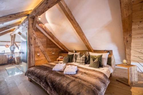 a bedroom with a large bed with two pillows at Obereggeralm in Valdaora