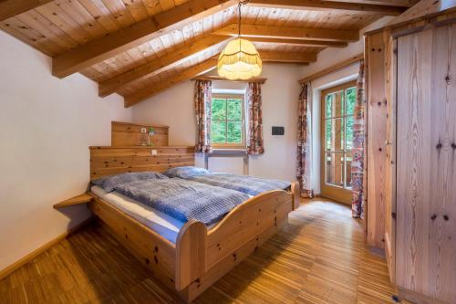 a bedroom with a bed and a chandelier at Lindenhof Apt 4 in Vandoies