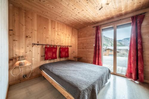 a bedroom with a bed in a room with a window at Sherpa - 10 pers in Saint-Jean-d'Aulps