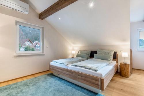a bedroom with a bed and a window at Ferienwohnung Kist in Sasbachwalden