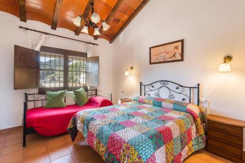 a bedroom with a bed and a window at Finca Liarte in Murcia