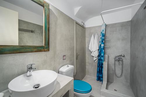 a bathroom with a sink and a toilet and a shower at Ammos 1 in Serifos Chora