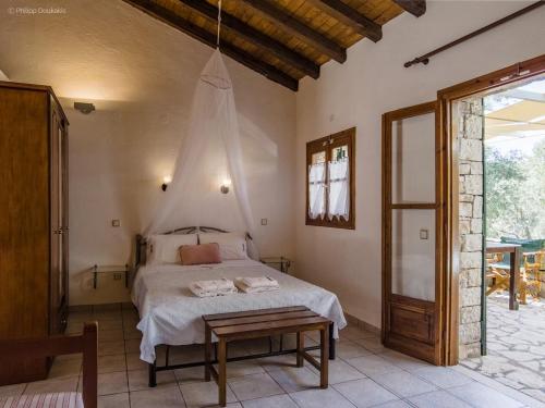 a bedroom with a bed with a mosquito net above it at Adamantia Studio S2 in Gaios