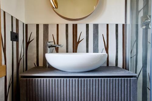 a bathroom with a large white sink on a counter at Bellagio - Baita treeb Tivano in Bellagio