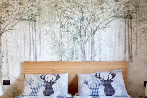a bedroom with a bed with a wall with trees at Bellagio - Baita treeb Tivano in Bellagio