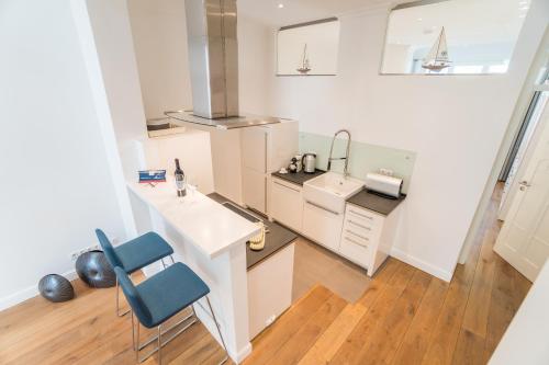 a kitchen with a counter and a sink and a stove at Appartement Baltic Pearl in Ostseebad Sellin