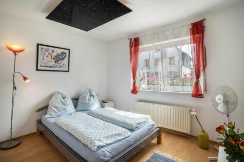 a bedroom with a bed and a window at Ferienwohnung Schläfer in Kappel-Grafenhausen
