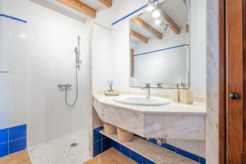 a bathroom with a sink and a shower at Finca can Mandai in Son Carrió