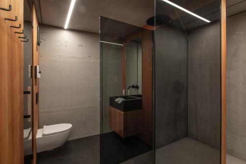 a bathroom with a sink and a glass shower at Ufogel in Nußdorf
