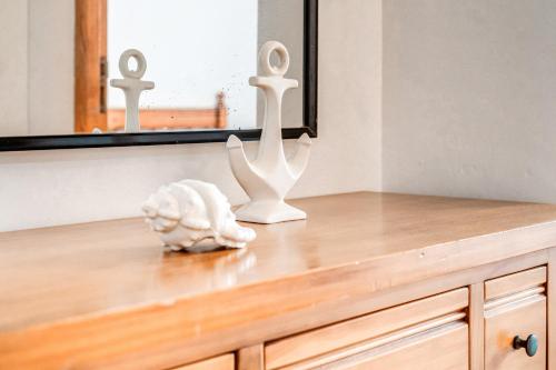 a dresser with two white candlesticks on top of it at Apartamentos Karin 1ºb in Santanyi