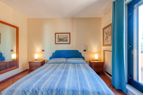 a bedroom with a blue bed with two night stands at Le dimore di Elia in Lecce