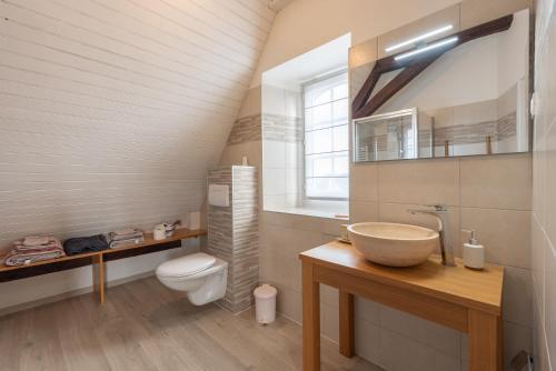 a bathroom with a sink and a toilet at Chambres D'hôtes Maison Galouÿe in Montgaillard