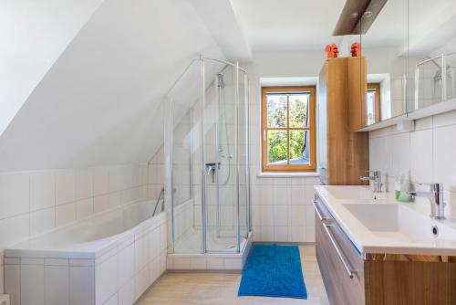a bathroom with a tub and a sink and a shower at Ferienwohnung Weiden in Weiden