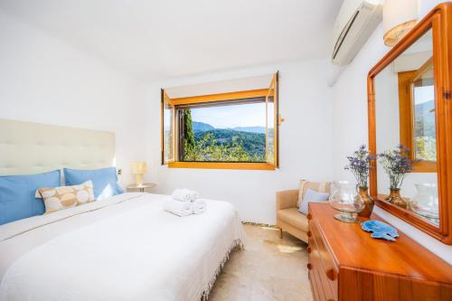 a bedroom with a bed and a window at Montemar 33 in Port de Soller