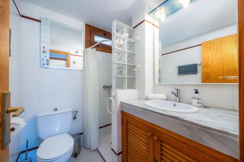 a bathroom with a toilet and a sink at Montemar 33 in Port de Soller