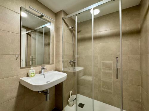 a bathroom with a sink and a glass shower at Beach Apartment with Pool, Terrace in Taramay
