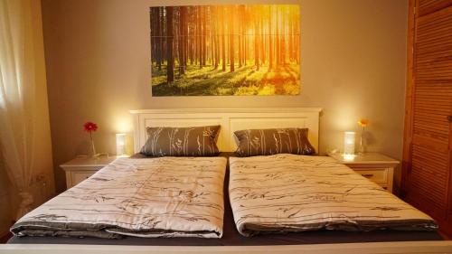 a bed in a bedroom with a painting on the wall at Casa Mia 2 in Bad Dürkheim