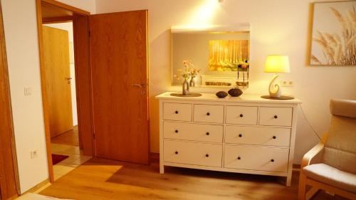 a bedroom with a dresser with a mirror on it at Casa Mia 2 in Bad Dürkheim