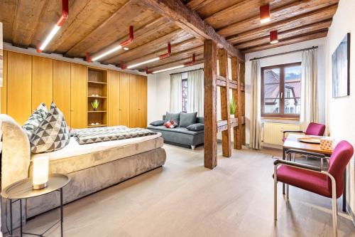 a large room with a bed and a couch at Ferienwohnung Marktblick in Pottenstein