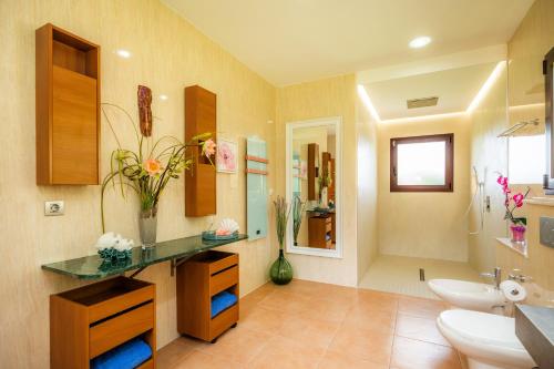 a bathroom with a sink and a toilet and a mirror at Luxurious villa Sol de Mallorca in Sol de Mallorca