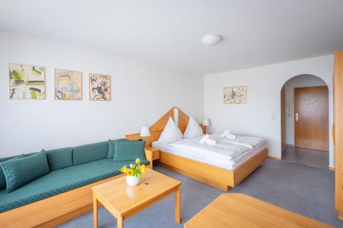 a living room with a couch and a bed at Fewo Schneckenhalde App 18 in Bad Säckingen
