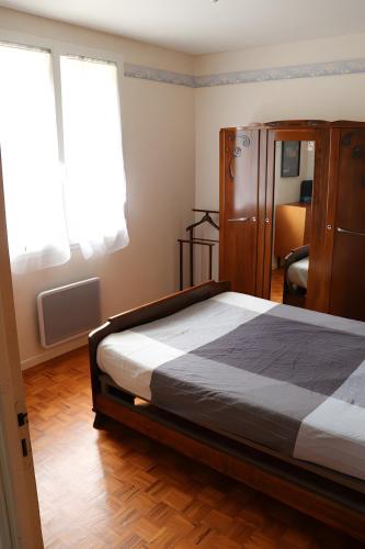 a bedroom with a bed and a dresser at Gite Chez Jeanne in Pern