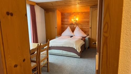 a bedroom with a bed in a wooden room at Birkenhof in Leutasch