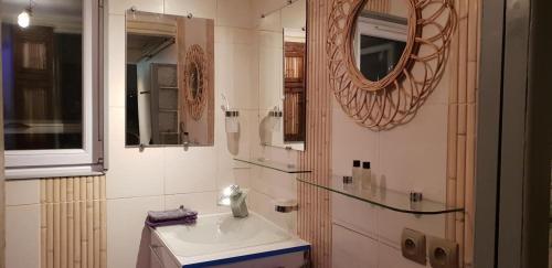 a bathroom with a sink and a mirror at Le Coq De Champagne in Dormans