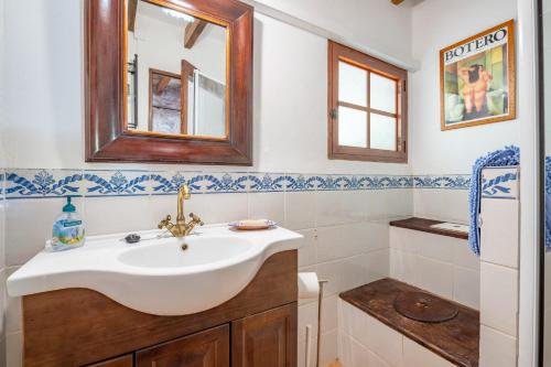 a bathroom with a sink and a mirror at S Olivar Major in Fornalutx