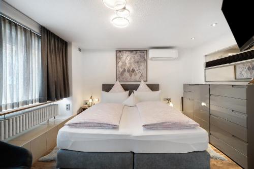 a bedroom with a large white bed in a room at Ferienwohnung Dina in Haslach im Kinzigtal