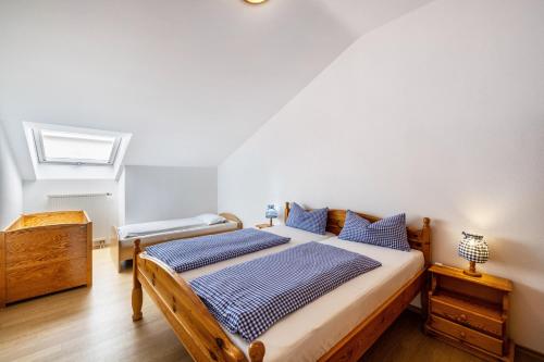 a bedroom with a bed with blue pillows at Fewo Brünnstein - Zimmer 55 in Oberaudorf