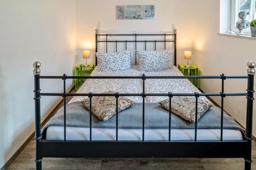 a bedroom with a black bed with pillows at Wohnung 4 in Wallhausen